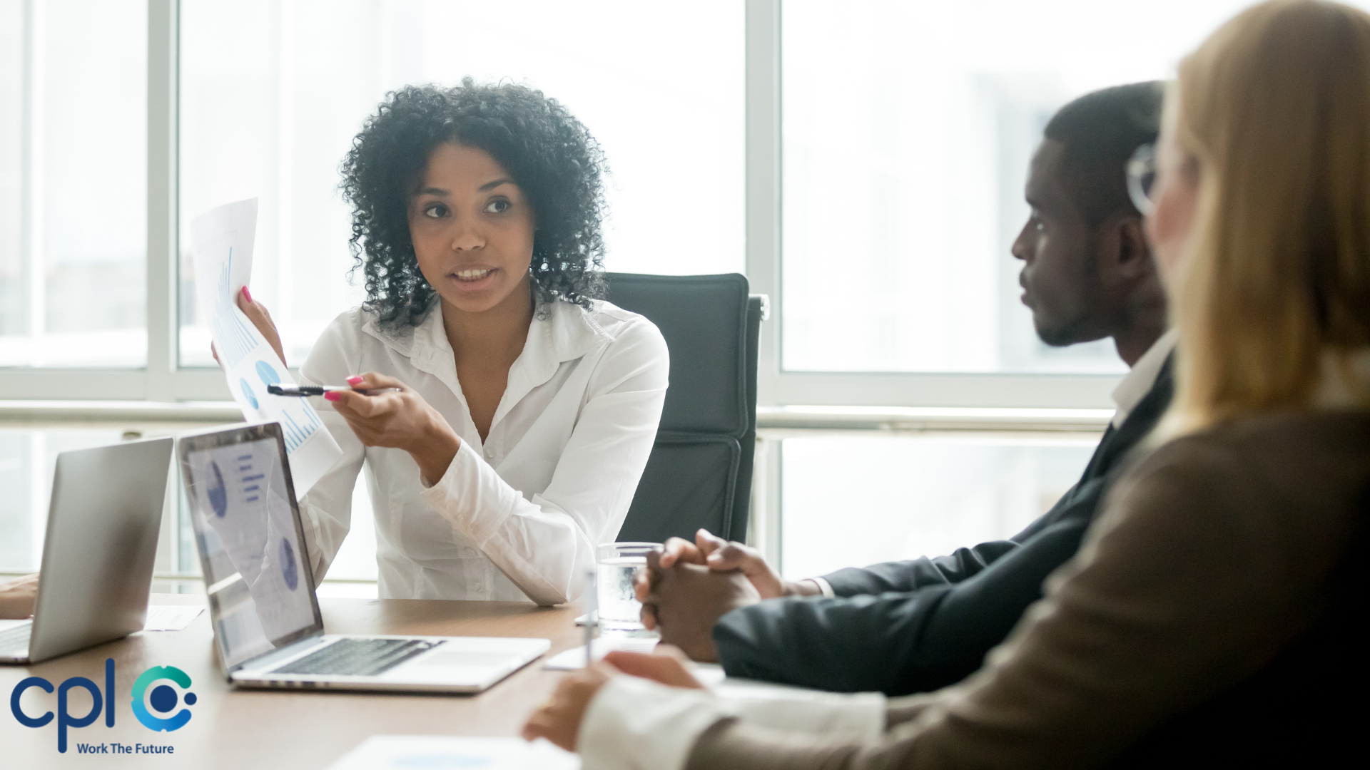 project manager delegating with team around a desk