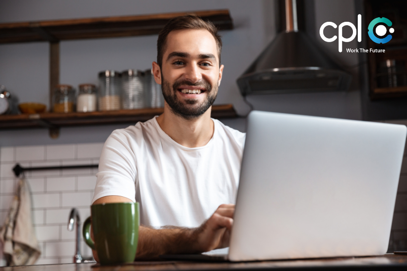 Male working from home, sitting at desk.