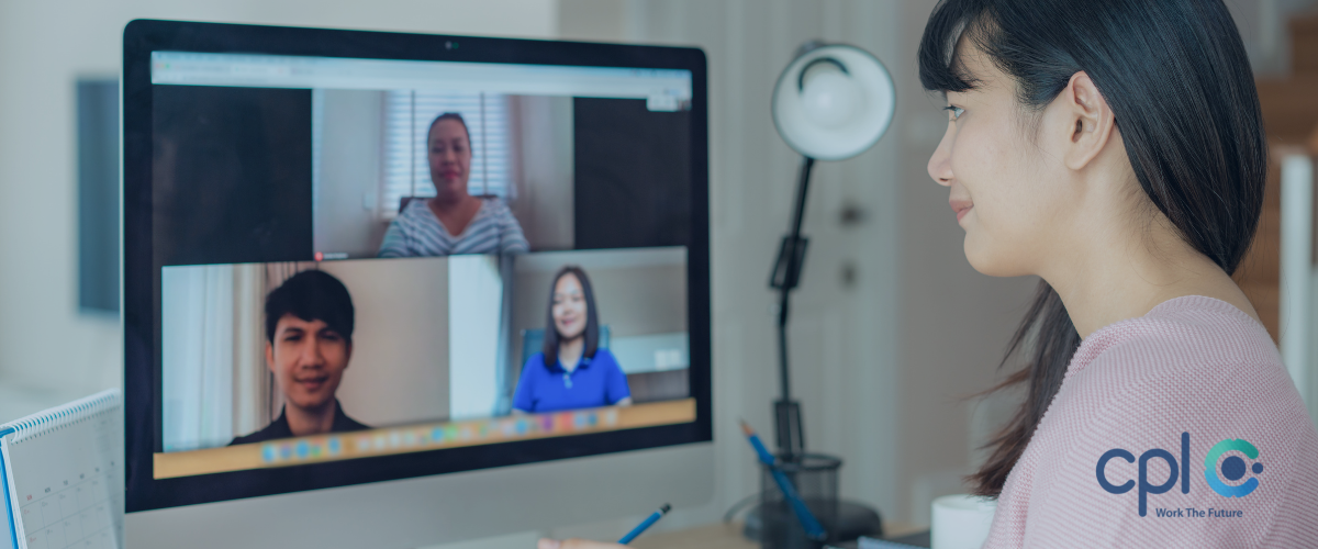 Female at desk participating in an online interview 