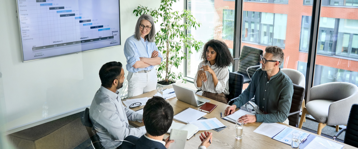 Cpl team members discussing a presentation in the meeting room