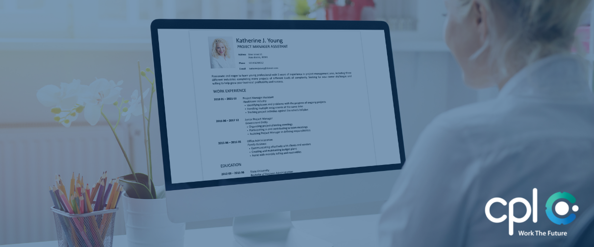Recruiter reviewing a candidate's resume on a computer screen